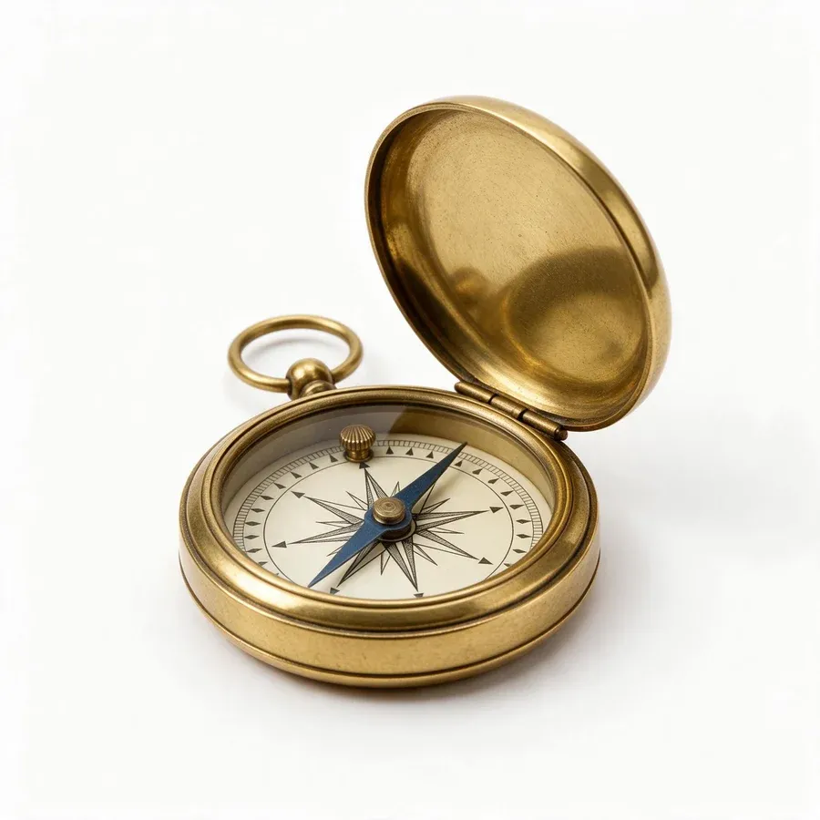 An open antique brass pocket compass with a cream dial, a blue needle and a ring at the top, on a plain white background
